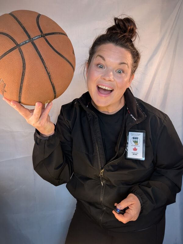 Cheyenne Sharpe holding a basketball over her head