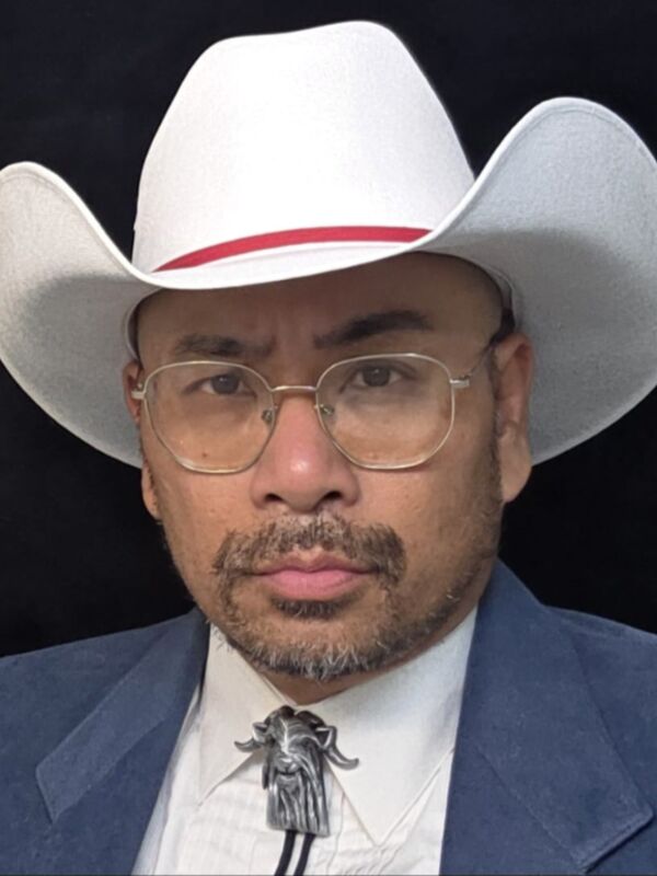 Jay B West the 4th in a white cowboy hat and bolo tie